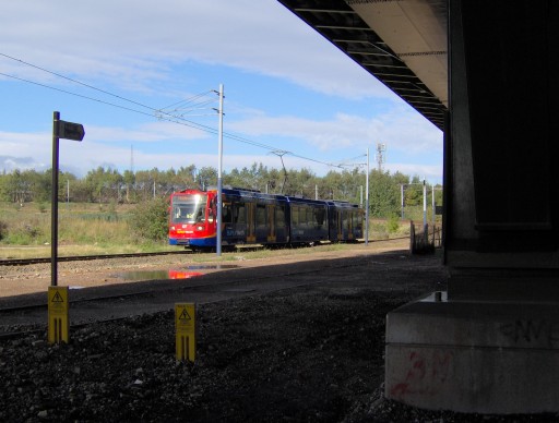 Yellow Route tram leaving Meadowhall in the shadow of Tinsley Viaduct